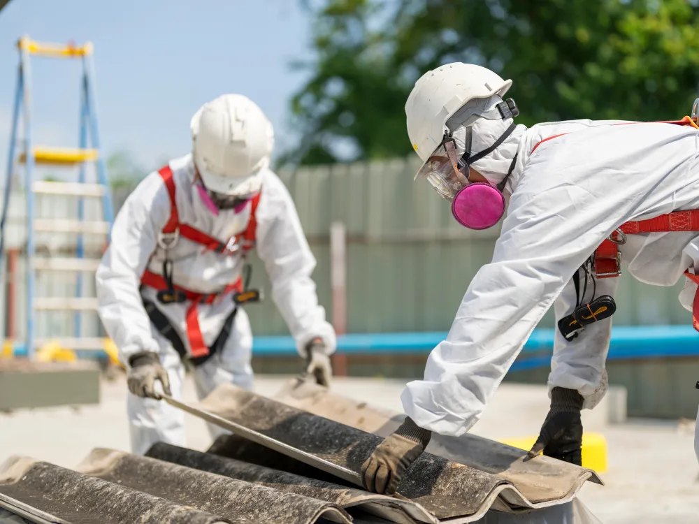Licensed asbestos removal specialists sealing hazardous material for disposal