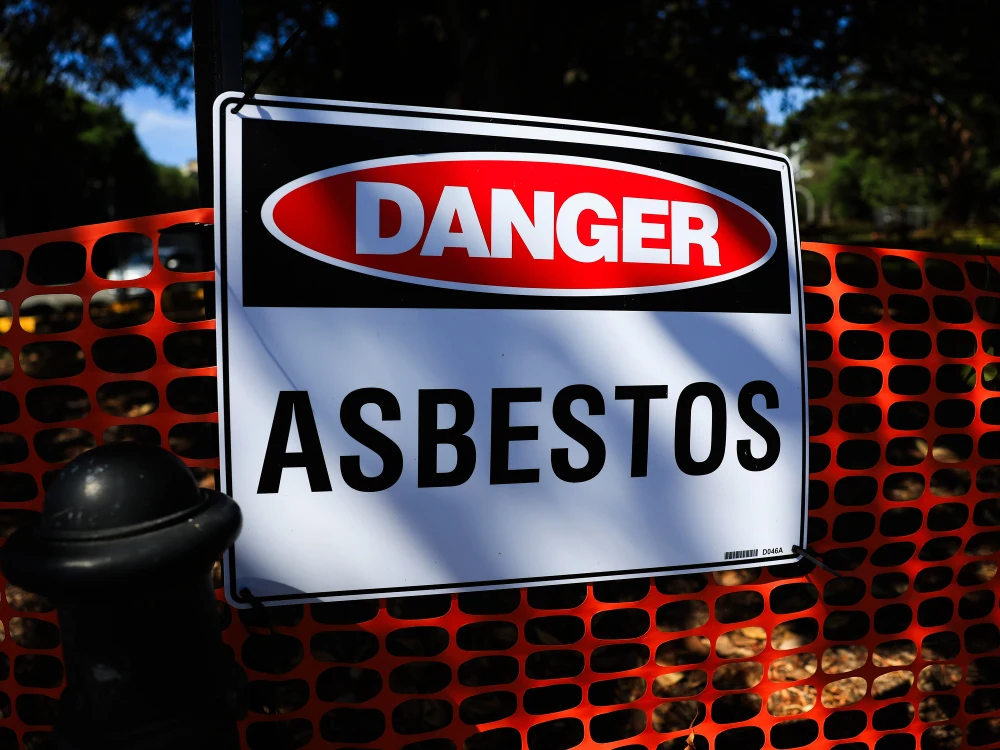 Licensed asbestos removal operatives performing safe containment and cleanup